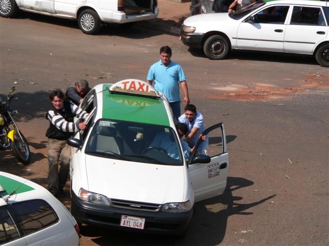 People pushing a taxi
