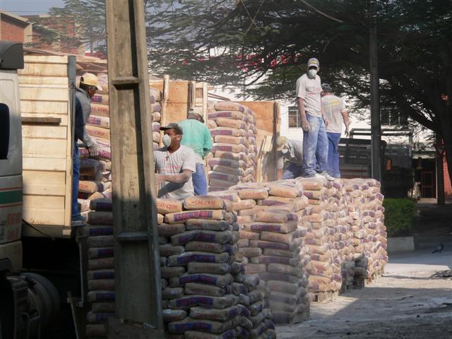 Men unloading cement