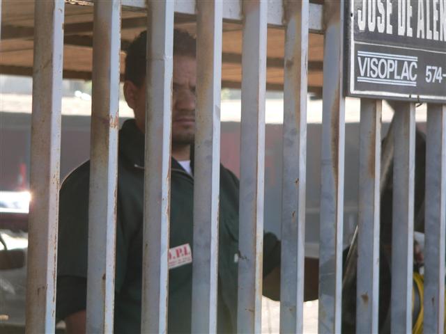 Man looking through bars