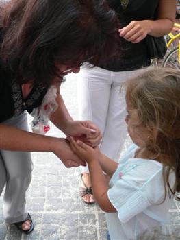Handing rice to a young girl