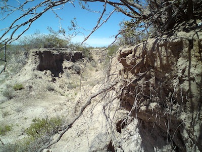 Heavily eroded walls line the way.